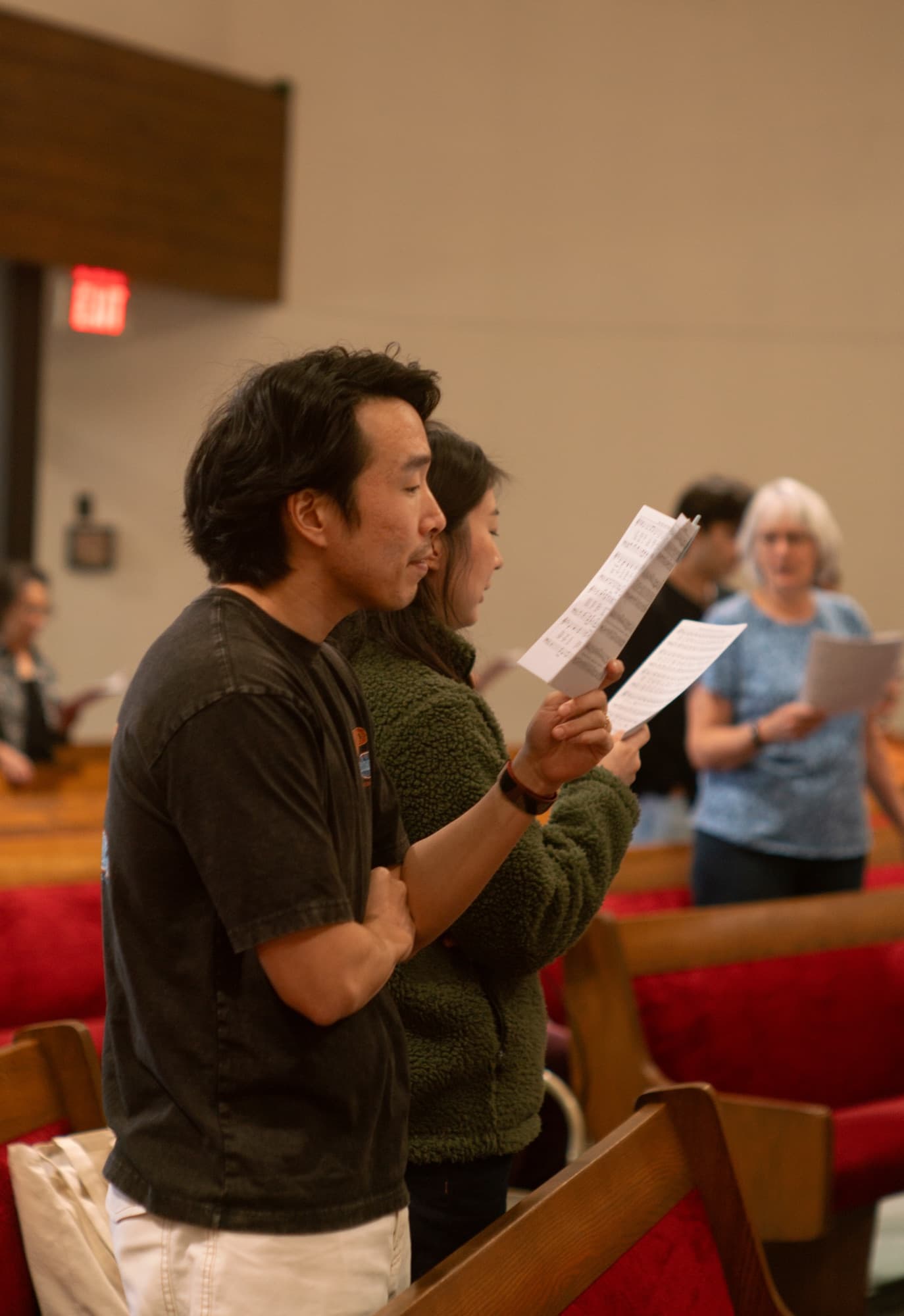 A couple singing during a Sunday service