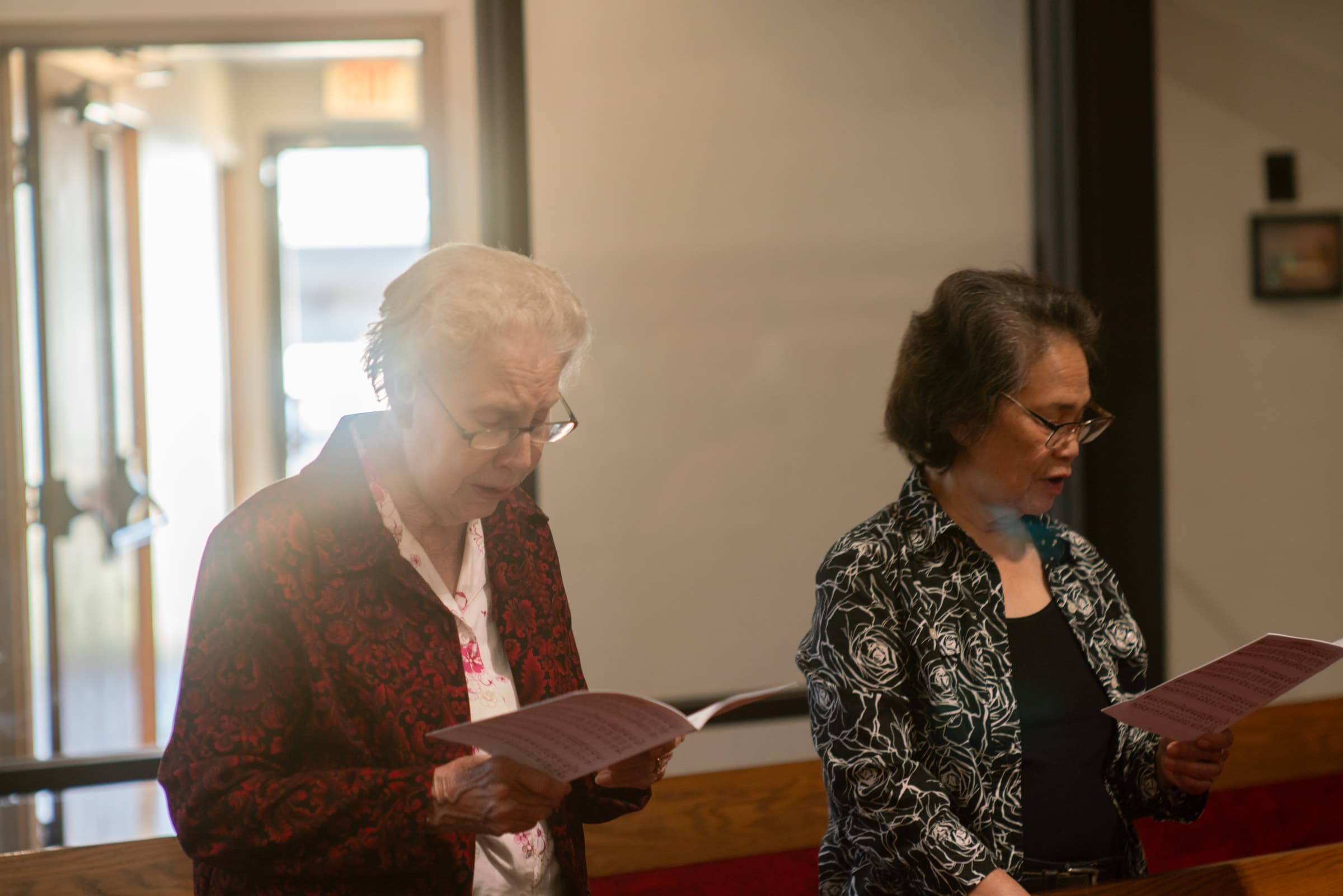 Church members reading from their hymn sheets