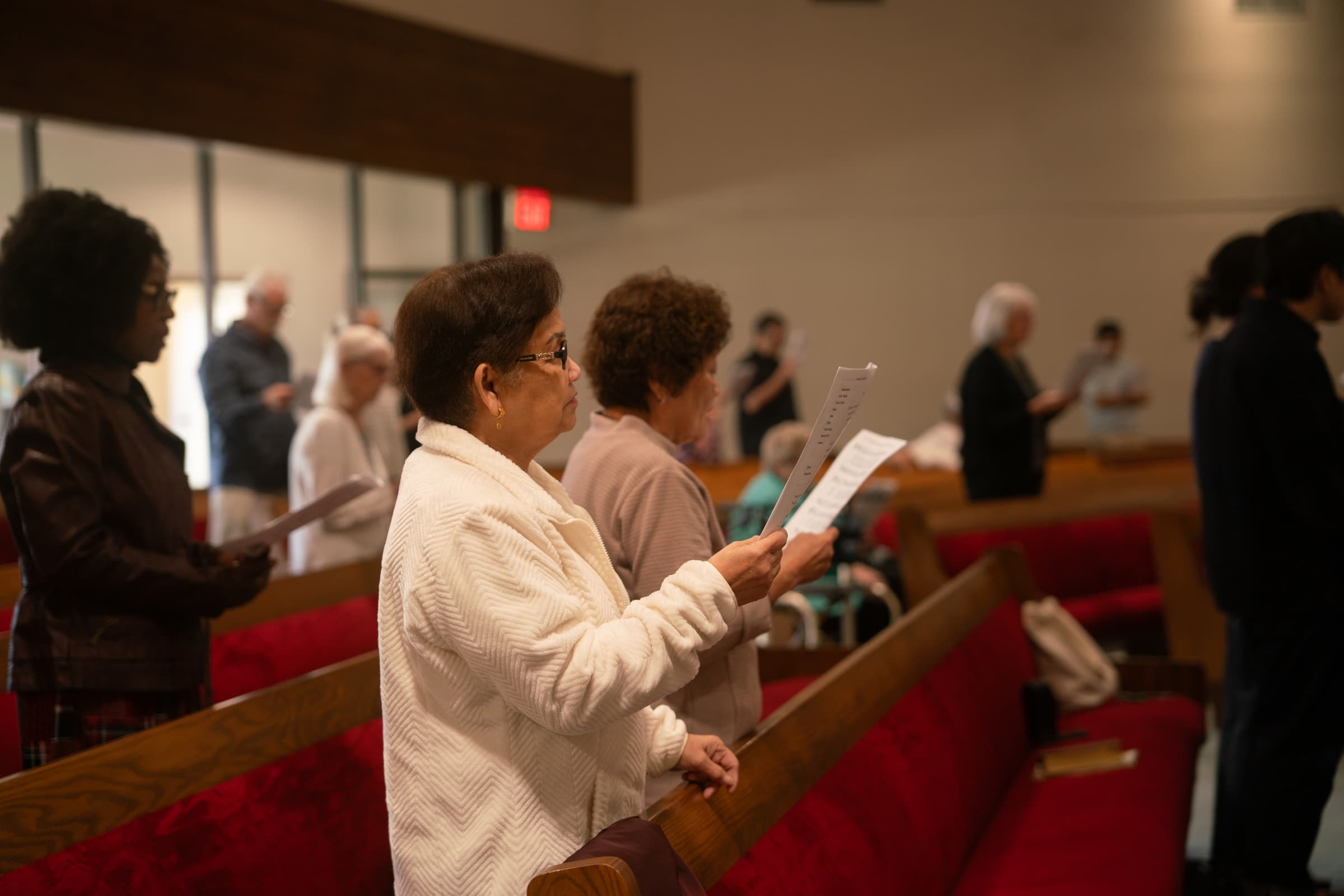 The congregation reading and singing together on Sunday